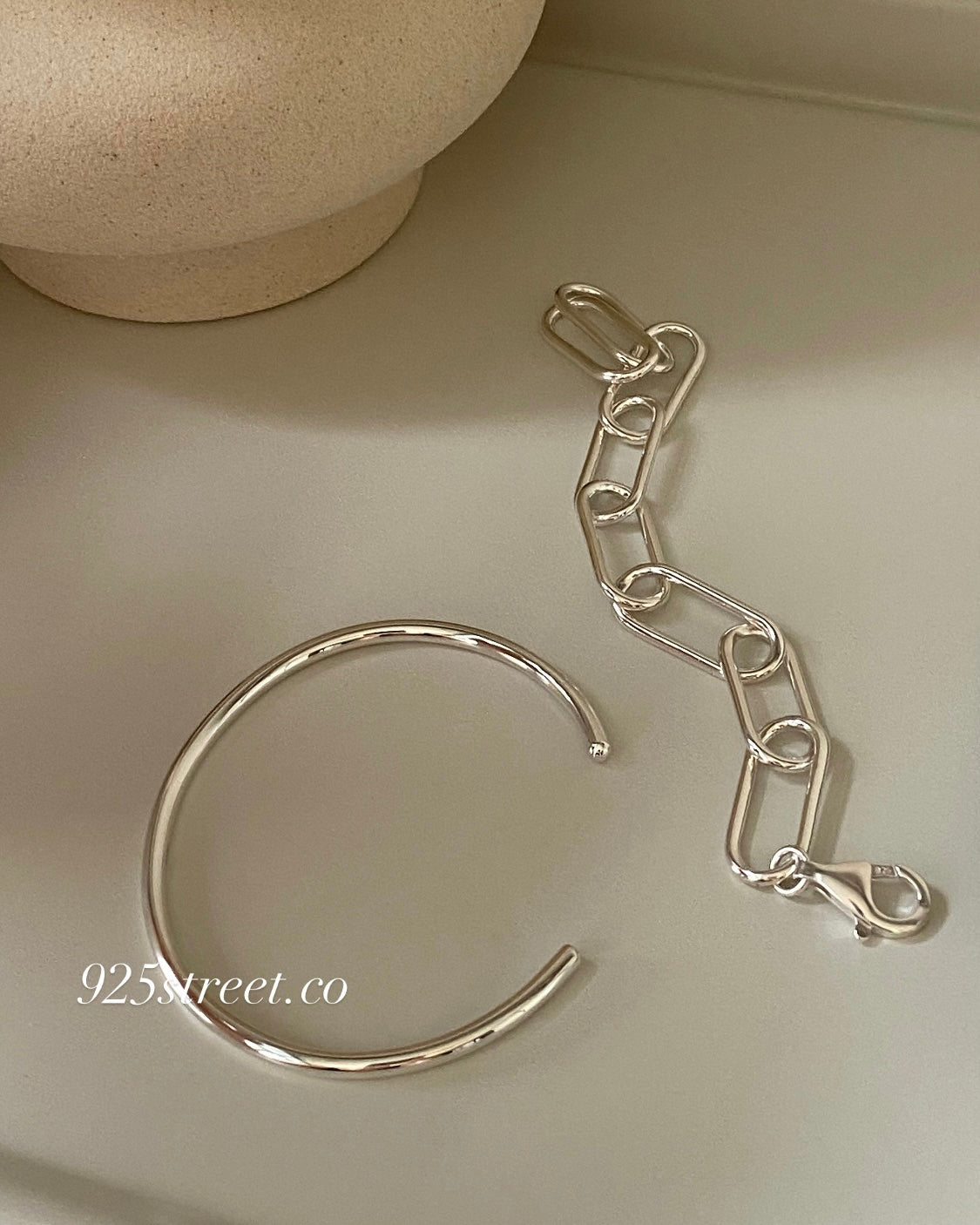 Close up of a minimalist 925 sterling silver open cuff bracelet showing smooth finish