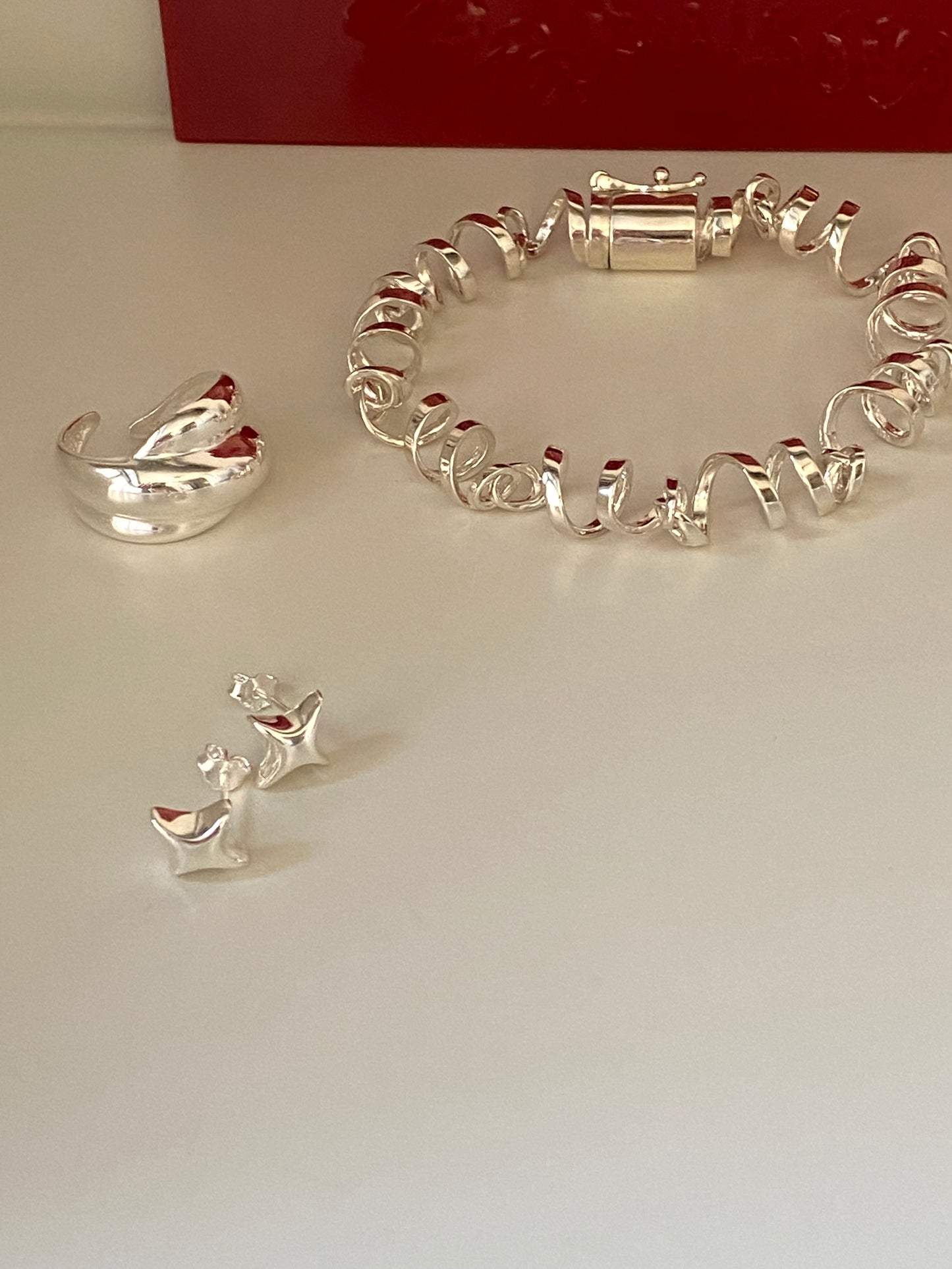 Sculptural sterling silver wire bracelet showing polished finish