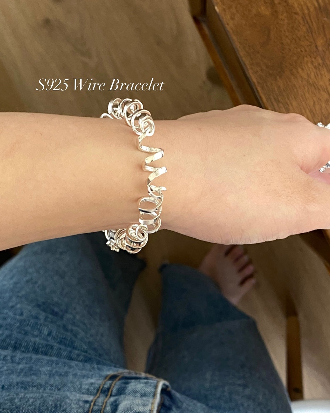 Close up of unique twisted 925 sterling silver ribbon links on a modern bracelet"